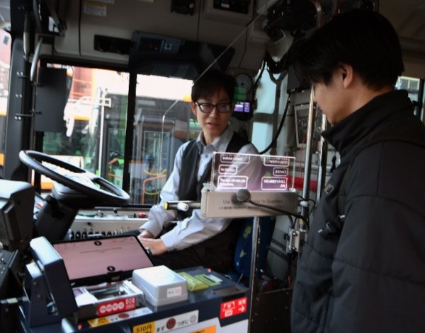 Image: Demonstration of the AI translation transparent display on a Toei Bus